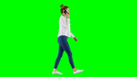 Smiling Brunette Walking And Talking on The Phone on Green Screen Video stock 124609580