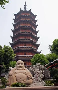 Smiling buddha statue in front of a distorted ruigang pagodda, suzhou, china Stock Photos