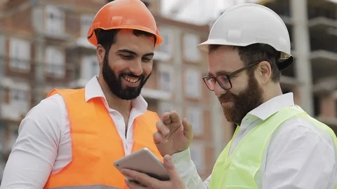 Smiling builder and architect man are discussing the construction plan of the Stock Footage 109488049
