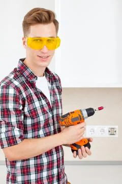 Smiling builder with a dril Stock Photos