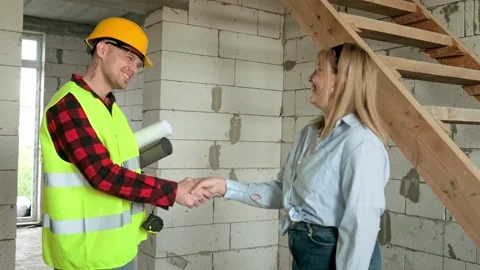 Smiling building specialists greeting each other before site inspection Stock Footage 270144516