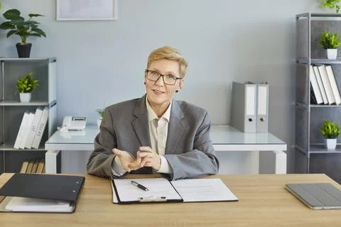 Smiling business coach explaining with open hands during online meeting in Stock Photos