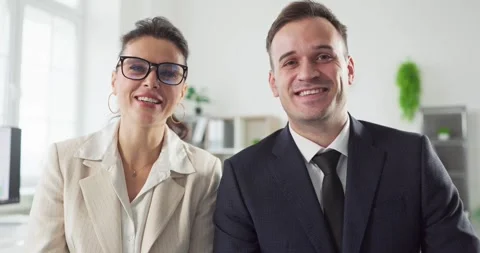 Smiling business colleagues on webcam during online video conference in office Stock Footage 329286979