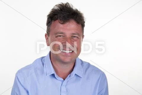 Smiling business man looking at camera with satisfaction Stock Photos
