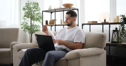 Smiling business man talking on video conference online use laptop at home Stock Footage