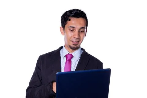 Smiling Business man using small dark blue laptop, isolated on all white Fotos de archivo