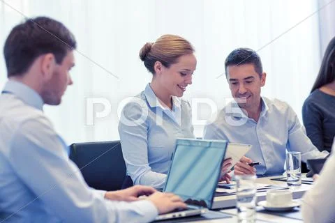 Smiling business people with tablet pc in office Stock Photos