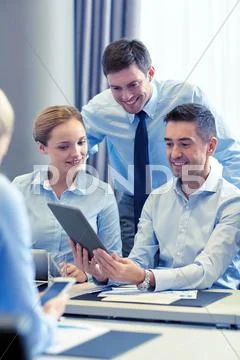 Smiling business people with tablet pc in office Stock Photos