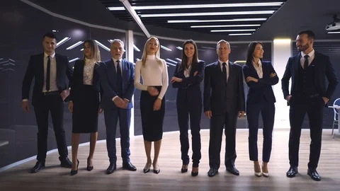 The smiling business team of eight posing on camera in the office Stock Footage 124728174