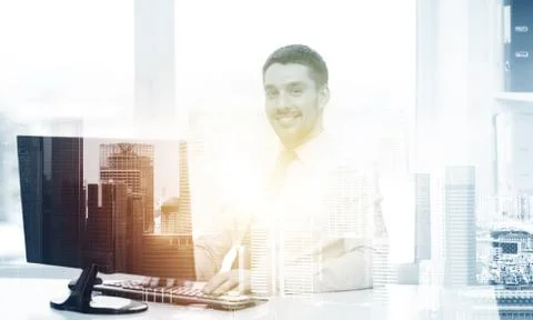 Smiling businessman with computer at office Stock Photos
