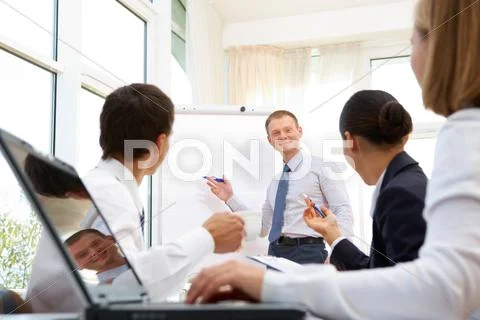 Smiling businessman explaining business ideas to his partners Stock Photos