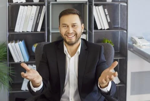 Smiling businessman gesturing to camera during remote office video meeting Stock-Fotos