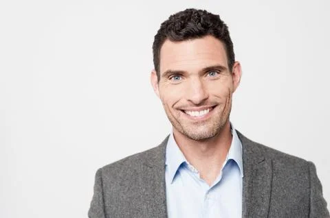 Smiling businessman posing to camera Stock Photos