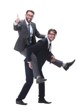 Smiling businessman sitting on the back of his colleague Stock Photos