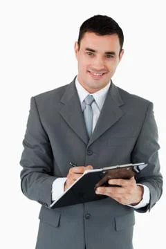 Smiling businessman taking notes Stock Photos
