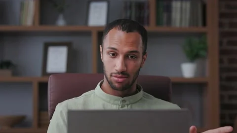 Smiling businessman talking to web camera sitting in office. Recording vlog 스톡 동영상 201346994