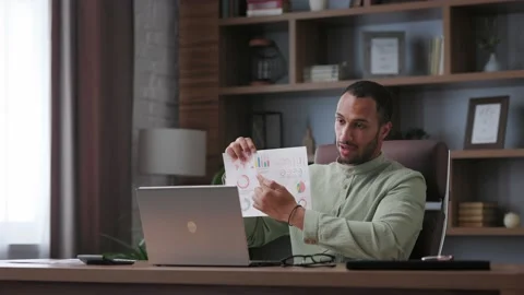 Smiling businessman talking to web camera sitting in office. Recording vlog 스톡 동영상 201673576