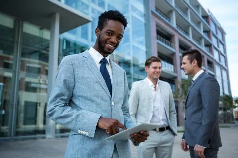 Smiling businessman using digital tablet in the office building Fotos de archivo