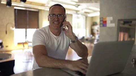 Smiling businessman working on laptop computer at home office. Male professional Stock Footage 209949150