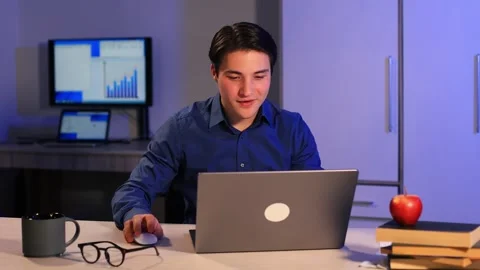 Smiling businessman working on laptop computer home office.Positive business man Stock Footage 262068635