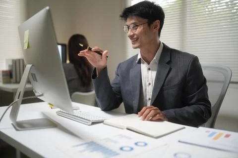 Smiling Businessman Working at Office Computer Stock Photos