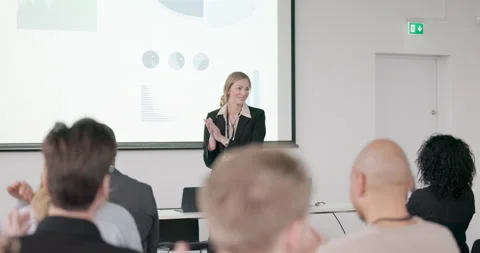 Smiling businesspeople clapping during presentation Stock Footage 256655311
