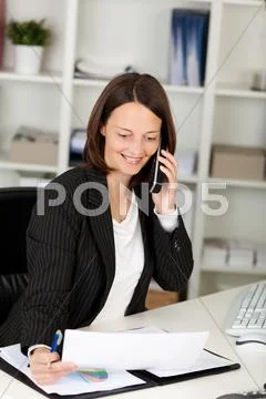 Smiling businesswoman chatting on the phone Stock Photos