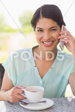 Smiling Businesswoman Having A Coffee Talking On Phone