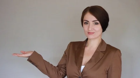 Smiling businesswoman presenting product. Young woman presentation Stock Footage