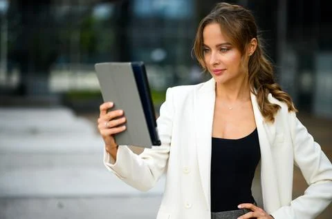 Smiling businesswoman using a digital tablet outdoor Stock Photos