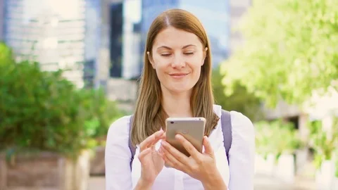 Smiling businesswoman in white shirt standing in downtown business district Stock Footage