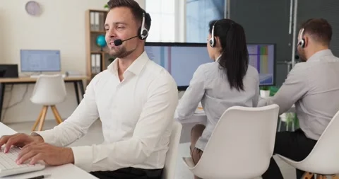 Smiling call center operator with headset providing customer service at office Stock Footage 341809177