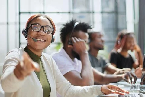 Smiling call center operator pointing at you Stock Photos