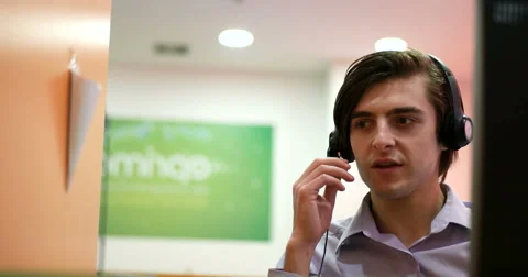 Smiling call centre agents using headsets 스톡 동영상 67255354