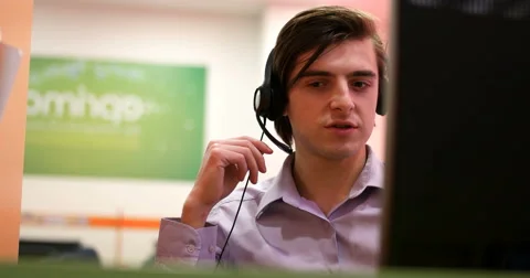 Smiling call centre agents using headsets 스톡 동영상 67256595