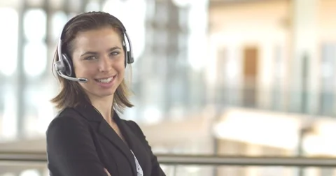 Smiling call centre customer service support operator receptionist woman headset Stock Footage 54799367