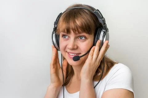 Smiling call centre operator with headset at workplace in call center Stock-Fotos