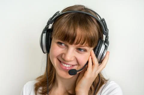 Smiling call centre operator with headset at workplace in call center Foto stock