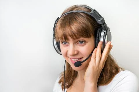 Smiling call centre operator with headset at workplace in call center Stock Photos