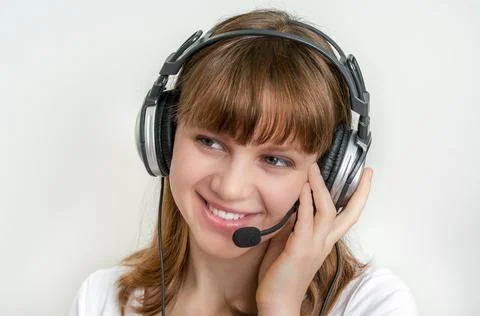 Smiling call centre operator with headset at workplace in call center Stock Photos