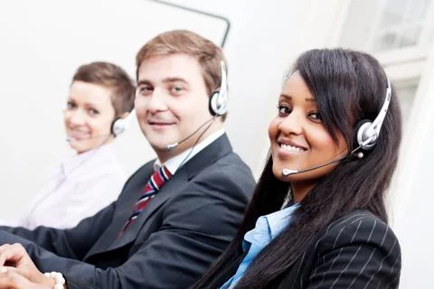 Smiling callcenter agent with headset support Stock Photos
