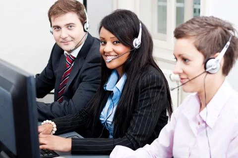 Smiling callcenter agent with headset support Stock Photos