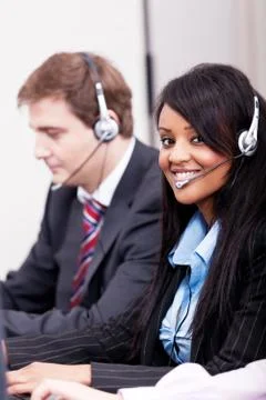 Smiling callcenter agent with headset support Stock Photos