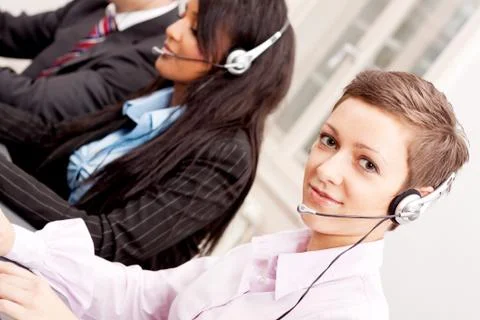 Smiling callcenter agent with headset support Stock Photos