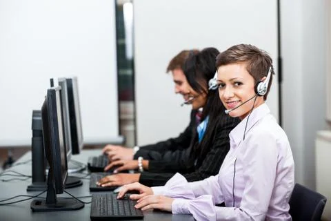 Smiling callcenter agent with headset support Foto stock