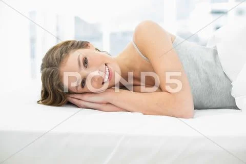Smiling calm woman resting in her bed Stock Photos