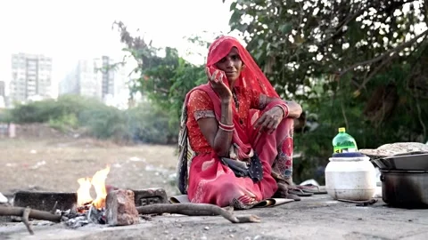 Smiling at the camera and preparing meals for his family sitting on the sidewalk Stock Footage 268946294