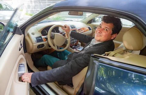 Smiling at Camera Driver of an Old Convertible Car Stock Photos