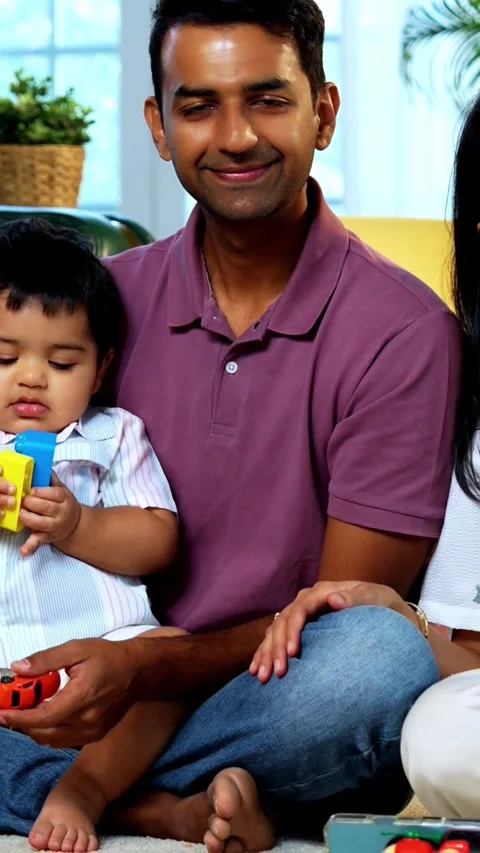 Smiling at camera together, Indian twin infant, young parents pose for photo 스톡 동영상 342757742