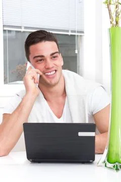 Smiling casual handsome man using mobile Stock Photos